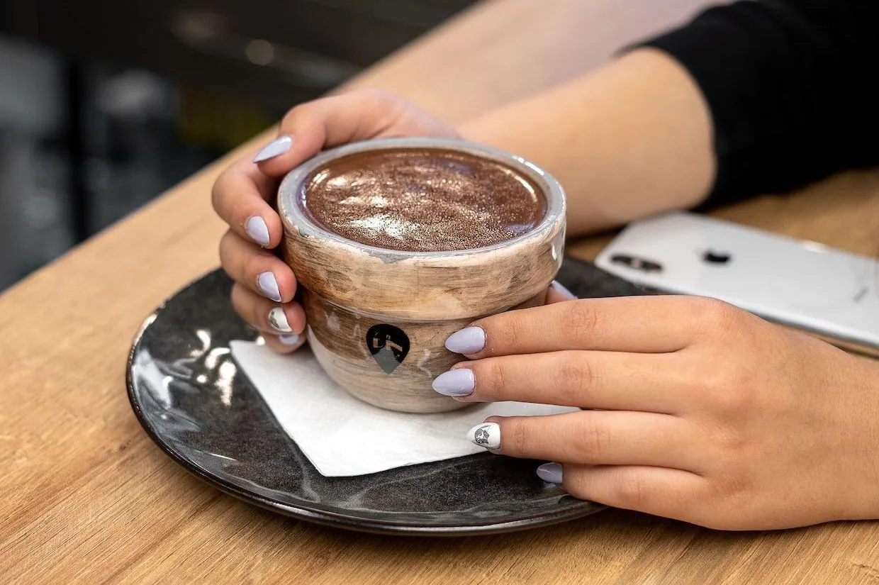 What We Touch with Our Hands May Affect What We Taste in the Cup